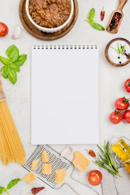Ingredients for bolognese spaghetti with notebook