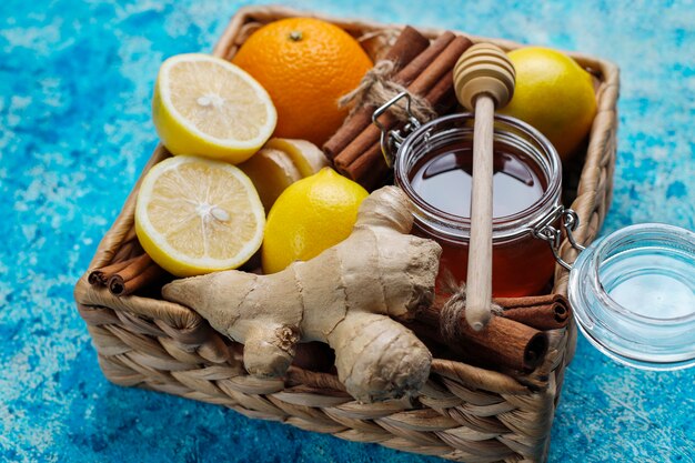 Ingredients: fresh ginger, lemon, cinnamon sticks, honey, dried cloves for making immunity boosting healthy vitamin drink