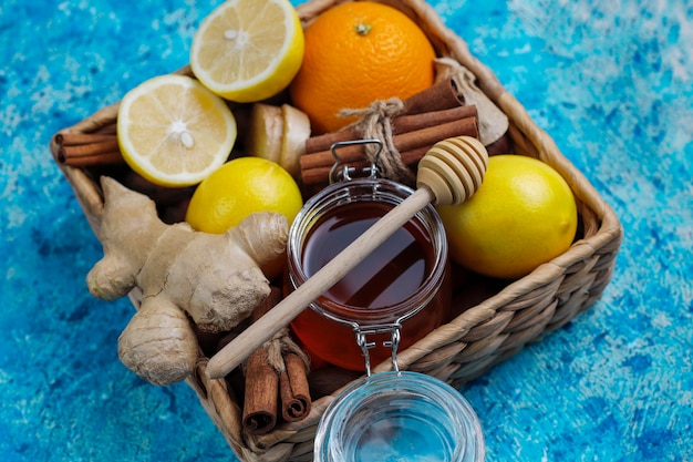 Ingredients: fresh ginger, lemon, cinnamon sticks, honey, dried cloves for making immunity boosting healthy vitamin drink