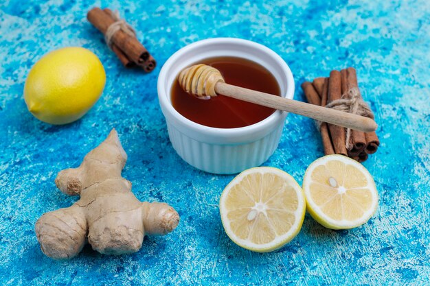 Ingredients: fresh ginger, lemon, cinnamon sticks, honey, dried cloves for making immunity boosting healthy vitamin drink