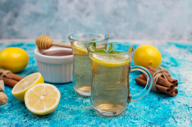 Ingredients: fresh ginger, lemon, cinnamon sticks, honey, dried cloves for making immunity boosting healthy vitamin drink