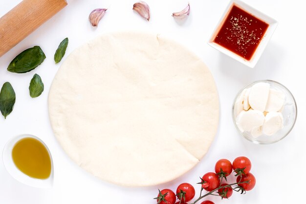 Ingredients for homemade pizza isolated on white background