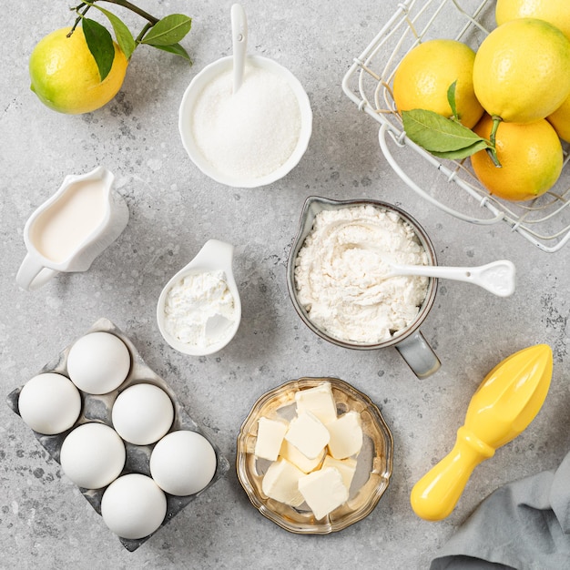 Free photo ingredients for making a pie with lemon curd and blueberries on a white stone table square