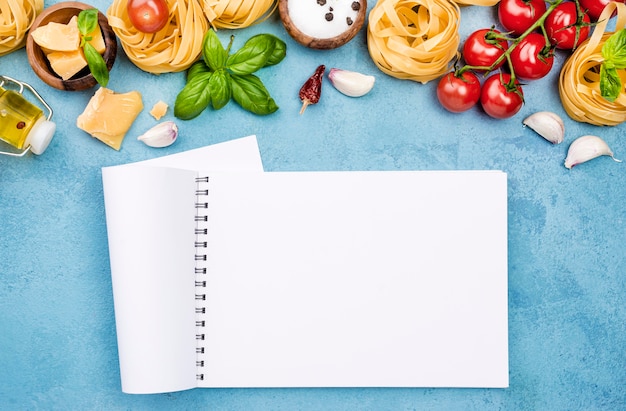 Ingredients for noodles with vegetables and notebook