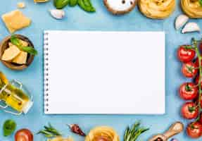 Free photo ingredients for noodles with vegetables and notebook