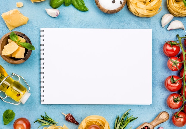 Ingredients for noodles with vegetables and notebook