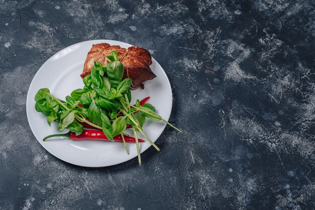 Ingredients on a plate on a dark concrete background