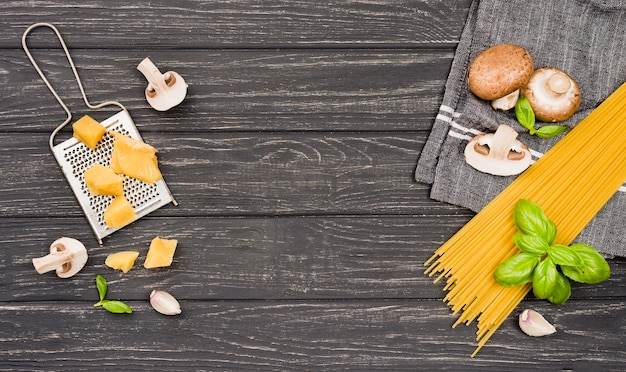 Ingredients for spaghetti with mushrooms on desk