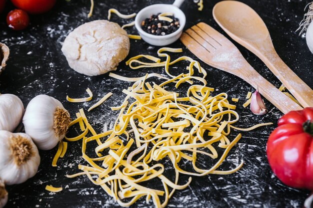 Ingredients and utensils around homemade pasta