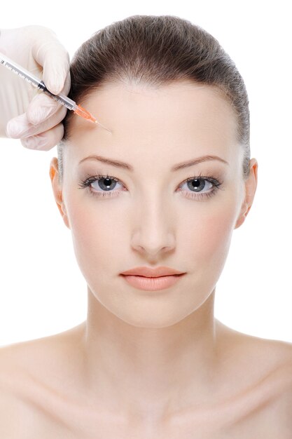 Injection of botox on female forehead