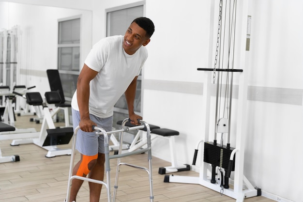 Injured man doing physiotherapy exercises for walking