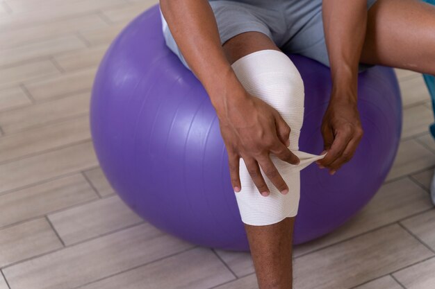 Injured man doing physiotherapy exercises for walking