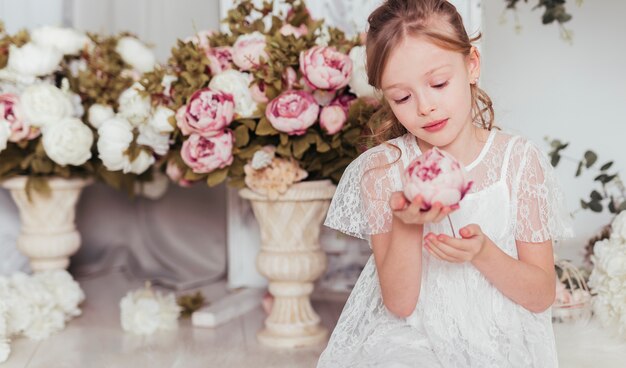 Innocent girl looking at flower