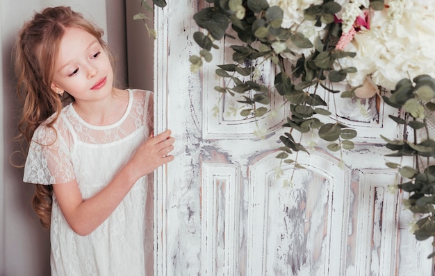 Innocent girl posing next to door