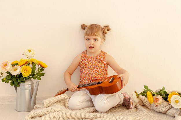 Innocent toddler holding guitar