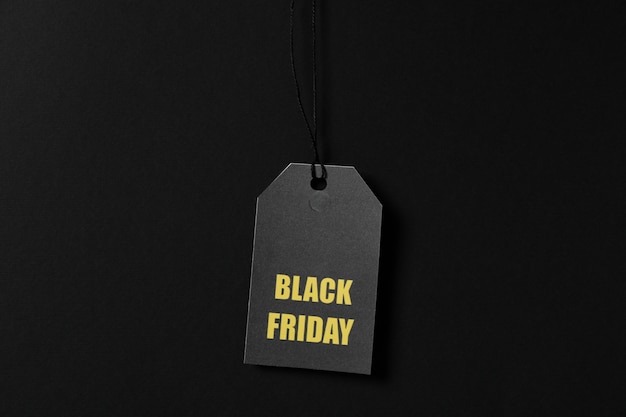 Inscription black friday on price tag on black space, copy space