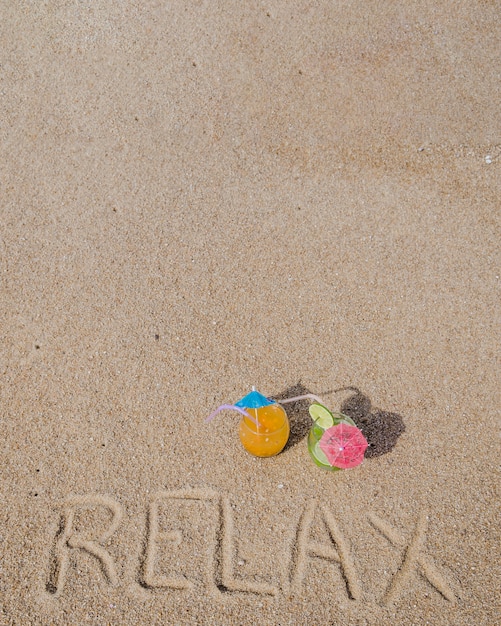 Inscription on sand with cocktails