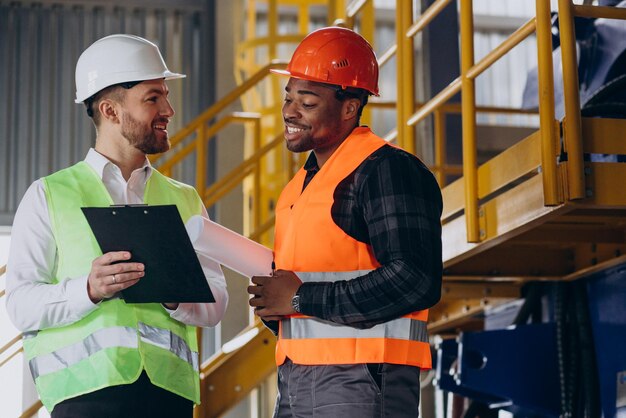 Inspector and african american worker in a factory