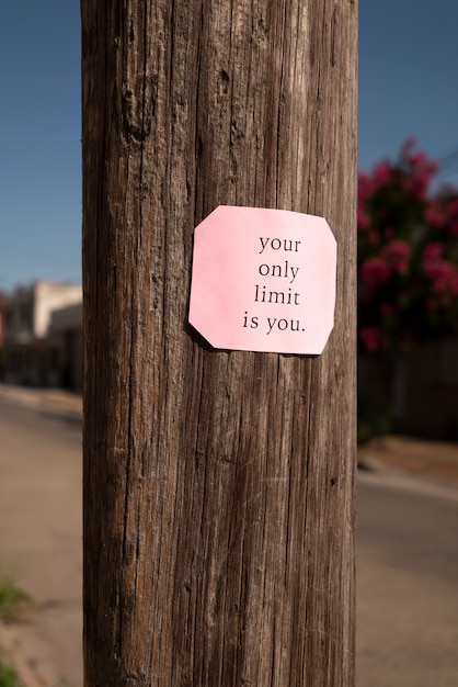 Free photo inspirational quote sticker on pole