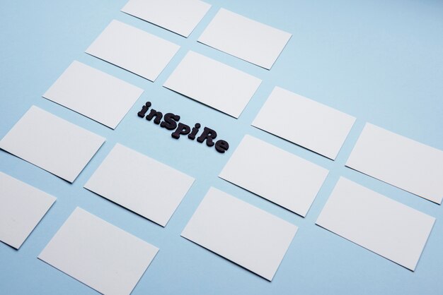 Free Photo inspire word surrounded by empty business cards