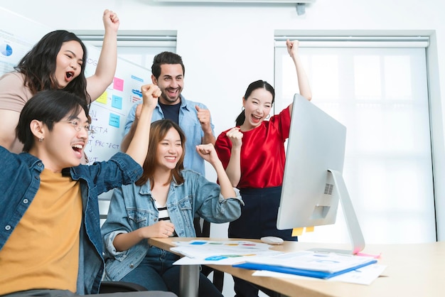 Inspire your teamwork to keep on achieving Group of Asian team creative business people hand raise up partnership teamwork concept modern office background