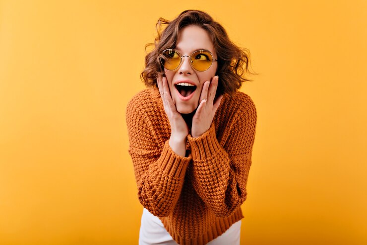 Free Photo inspired white female model in vintage sunglasses looking away with surprised smile