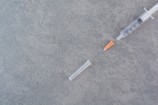 Insulin syringe for diabetes on marble table.