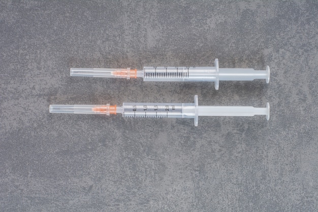 Insulin syringes for diabetes on marble table.
