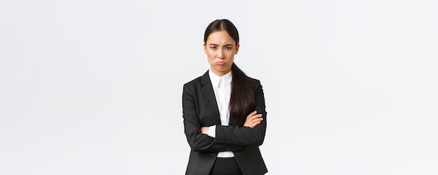 Free photo insulted silly pouting saleswoman feeling angry at coworker cross arms and sulking mad frowning disp