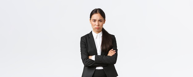 Insulted silly pouting saleswoman feeling angry at coworker cross arms and sulking mad frowning disp