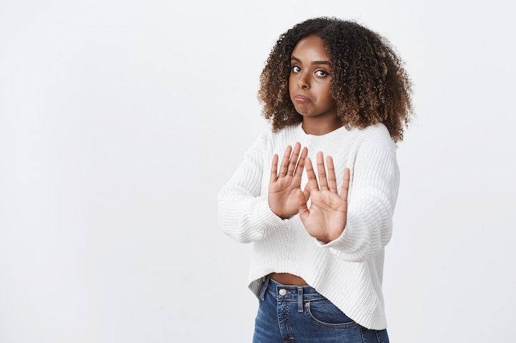 Free Photo intense displeased and disappointed woman unwilling participate in suspicious action pulling hands towards camera in stop and refusal gesture pursing lips in dislike, rejecting offer