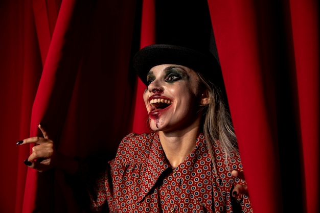 Intense shot of a halloween make-up woman laughing