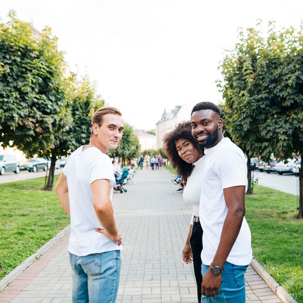 Intercultural friends looking backward at camera