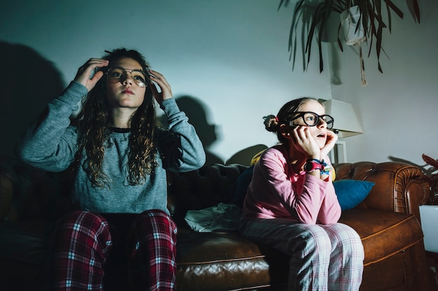 Free photo interested girls watching tv