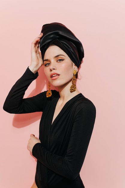 Free photo interested young lady touching turban