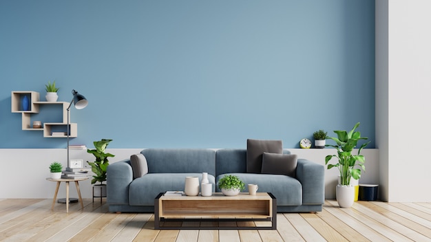 Interior of a bright living room with pillows on a sofa , plants and lamp on empty blue wall.