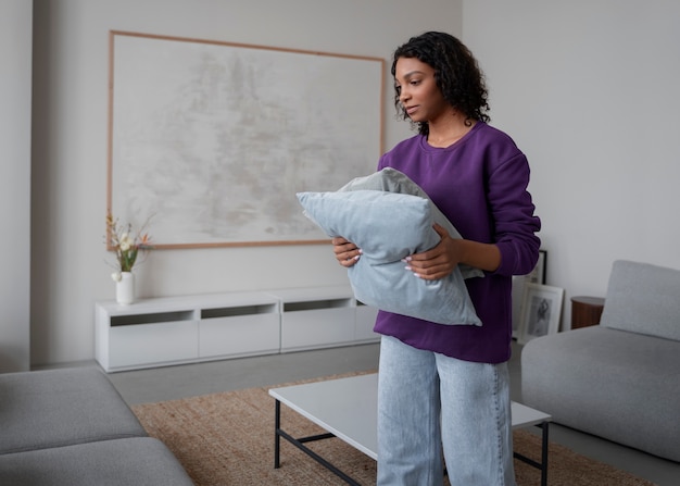 Interior designer arranging pillows in home