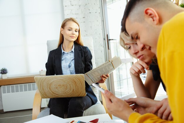 Interior designer working with young couple