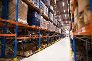 Free photo interior of large distribution warehouse with shelves stacked with palettes and goods ready for the market