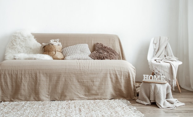 The interior of the living room with a sofa and decorative items.