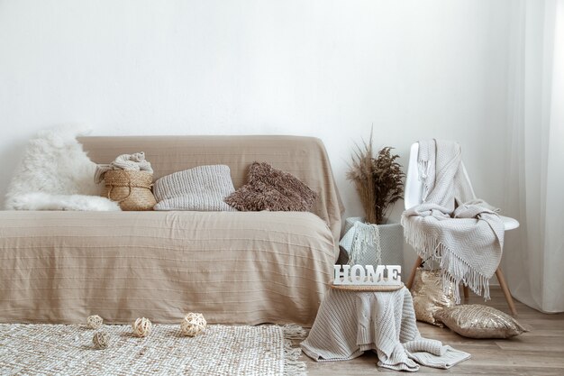 The interior of the living room with a sofa and decorative items.