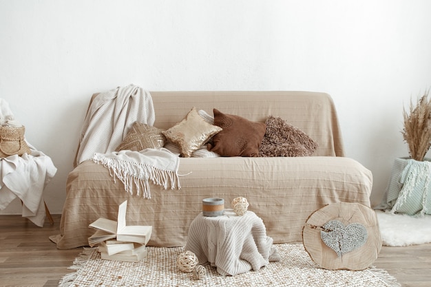 The interior of the living room with a sofa and decorative items.