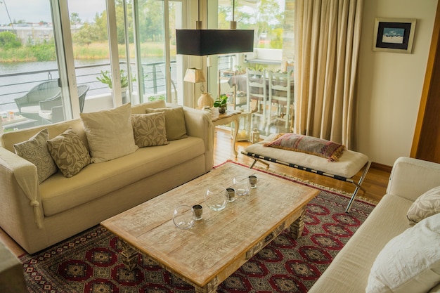 Interior of a modern apartment decorated comfortably with huge windows