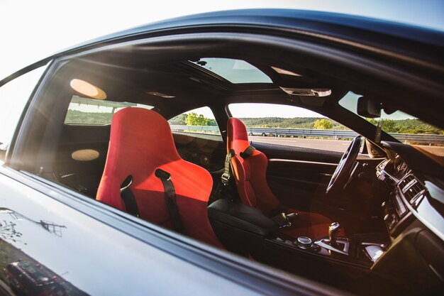 Interior, red saloon of a black luxury sedan car.