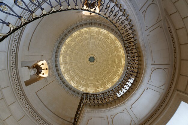 Interior shot of spiral stairs with a sculpted ceiling