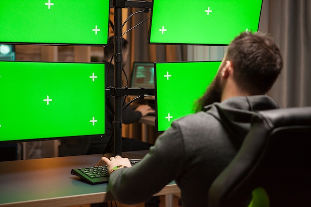 Free photo international hacker planning a cyber attack on computer with green chroma key.