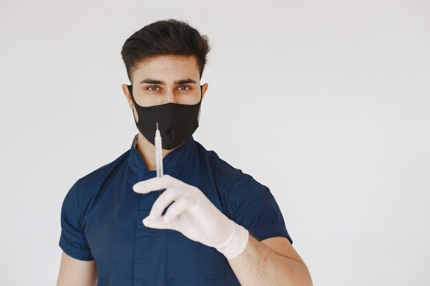 International medical student. Man in a blue uniform. Doctor in a mask.