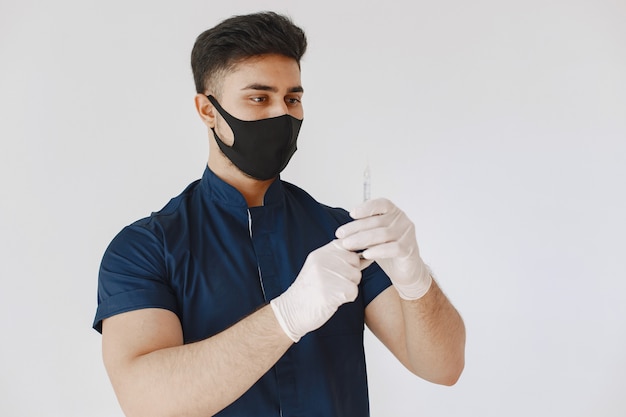 International medical student. Man in a blue uniform. Doctor in a mask.