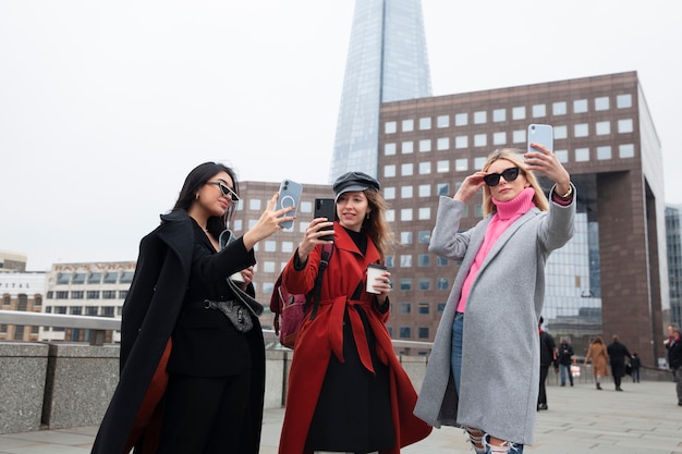 Internet celebrities taking a selfie on a bridge in the city