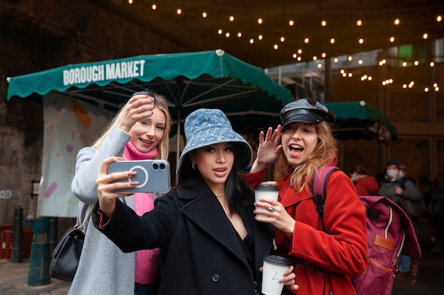 Free photo internet celebrities taking a selfie at the market